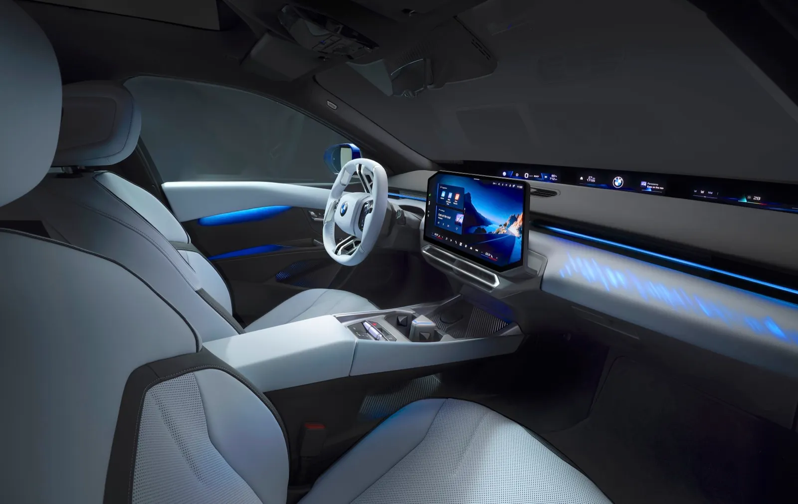 Vue de l'intérieur d'une BMW i3 2026, montrant le tableau de bord numérique et l'écran central iDrive.