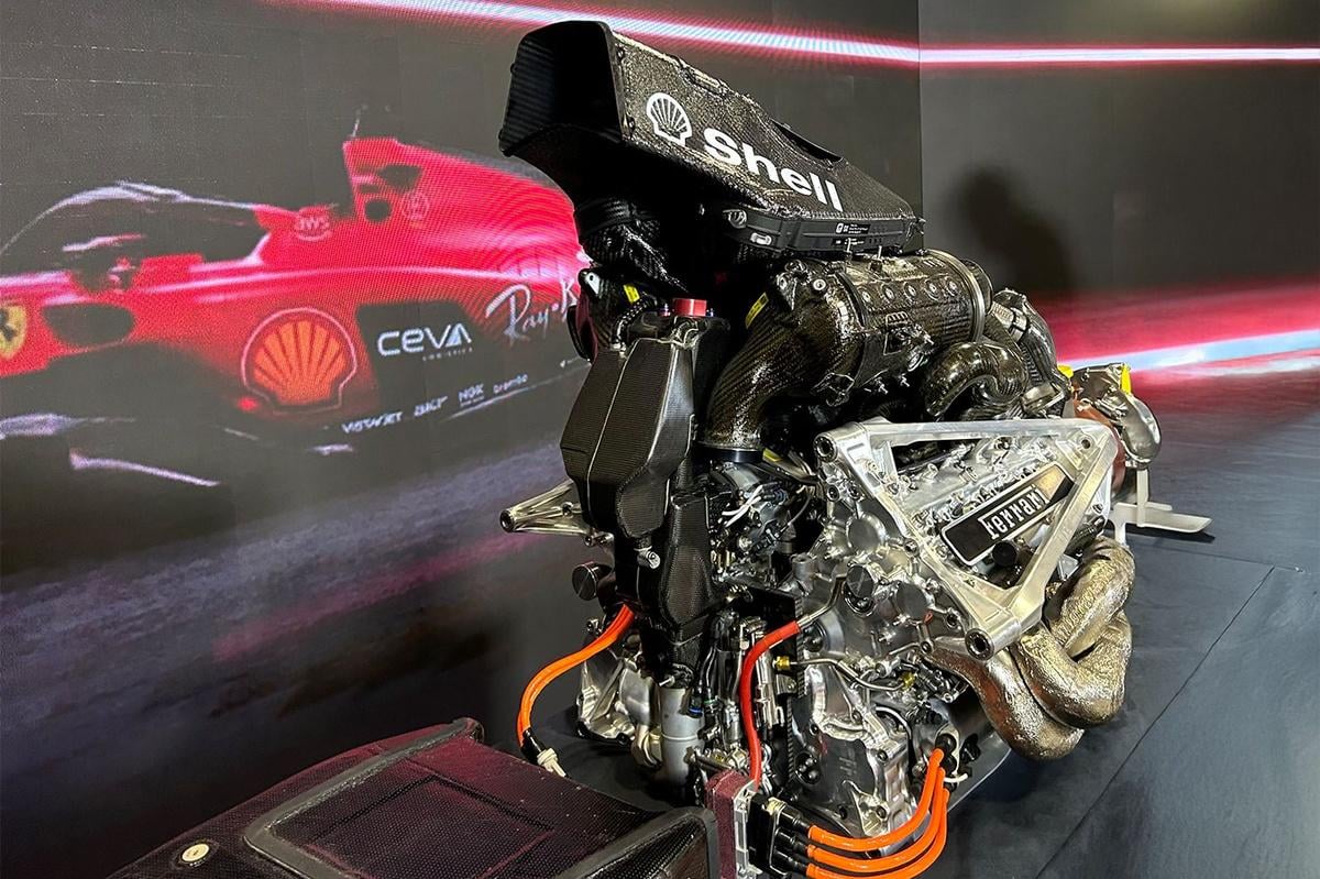 Vue détaillée d'un moteur de Formule 1 Ferrari futuriste, avec des composants hybrides complexes.