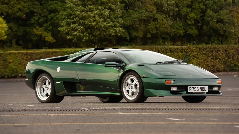 Une Lamborghini Diablo SV-R bleue de 1997 sur une piste de course, avec un flou de mouvement.