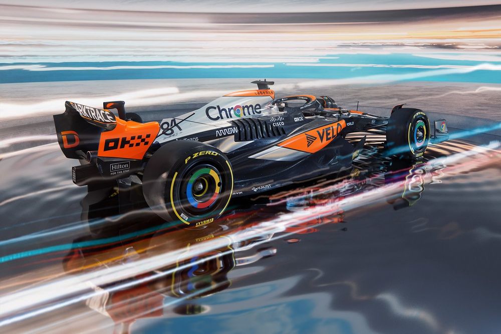 Une voiture de Formule 1 McLaren avec une livrée spéciale rétro orange, blanche et rouge, en action sur le circuit de Silverstone.