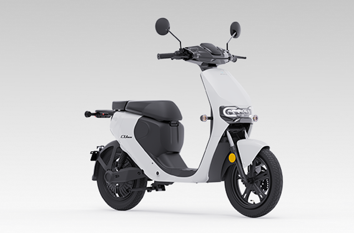 Une personne soulève légèrement l'arrière d'un scooter électrique VMoto CU ou CUmini, démontrant sa légèreté et sa facilité de manipulation pour le stationnement ou les manœuvres.