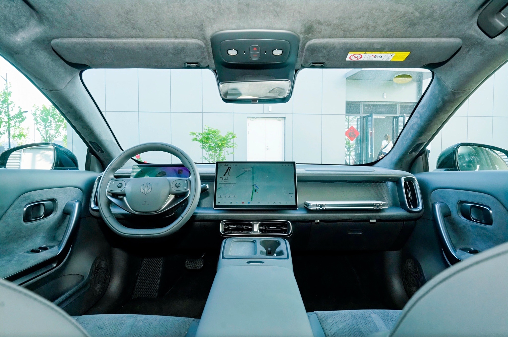 Intérieur d'une Leapmotor B05, montrant le tableau de bord avec un grand écran tactile et un design épuré.