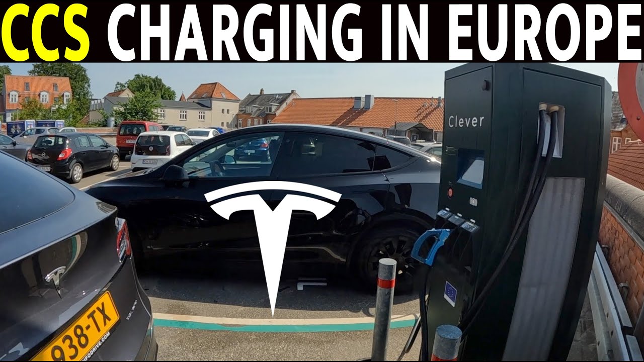 Une Tesla Model Y bleue est branchée à une borne de recharge Tesla Supercharger dans un environnement urbain européen.