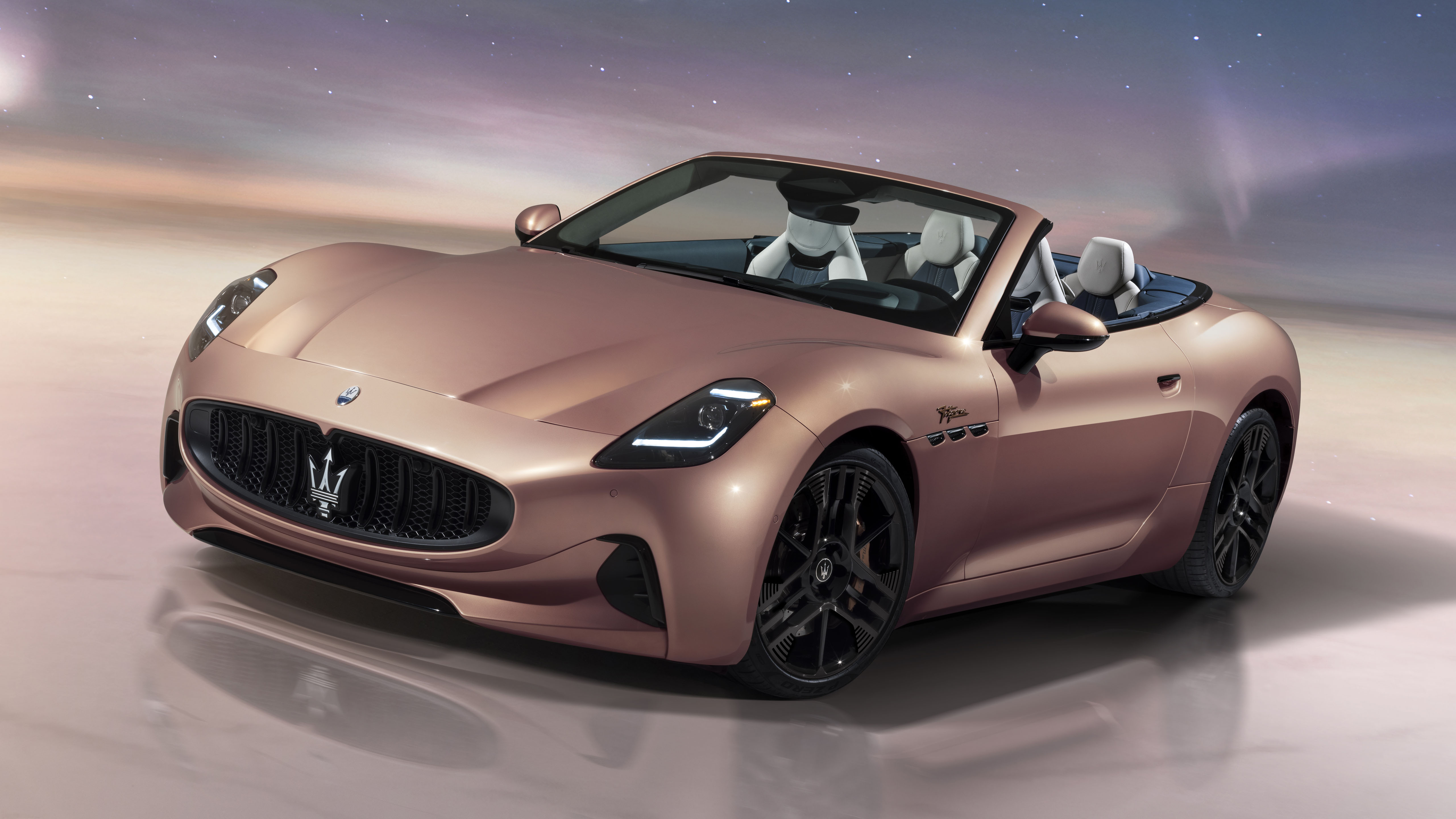 Une Maserati GranTurismo Folgore électrique, de couleur sombre, garée dans un environnement moderne et épuré.