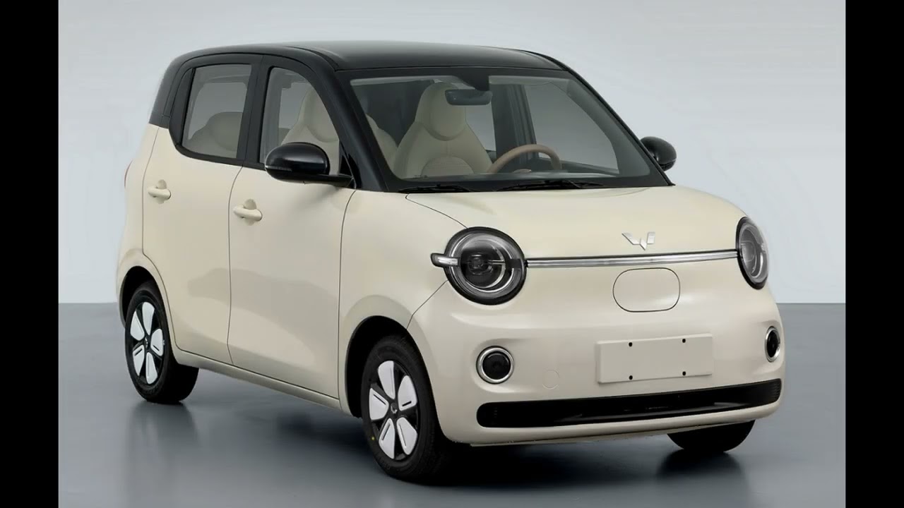 Une Wuling Hongguang Mini EV 2026 verte en mouvement dans une rue de ville animée.