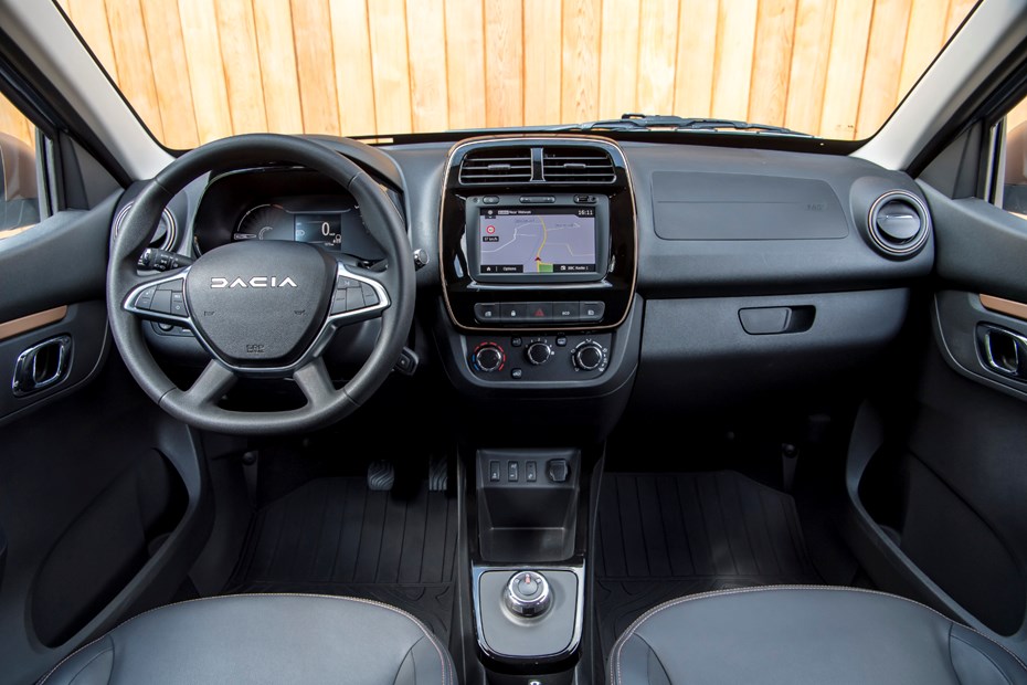 Vue de l'intérieur de la Dacia Spring 2026, montrant le tableau de bord avec un écran numérique et un écran central.