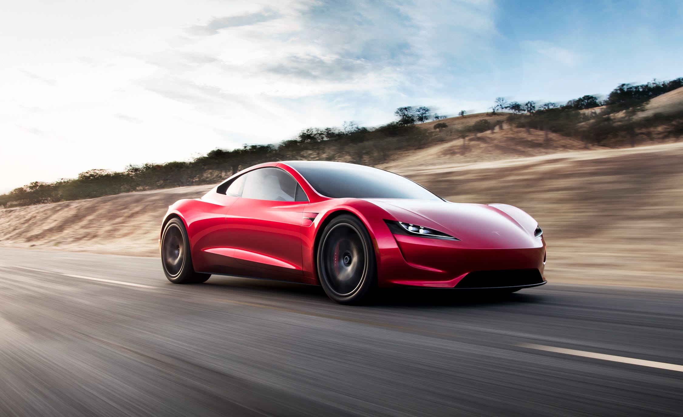 Une Tesla Roadster 2024, au design aérodynamique, garée dans un environnement moderne.