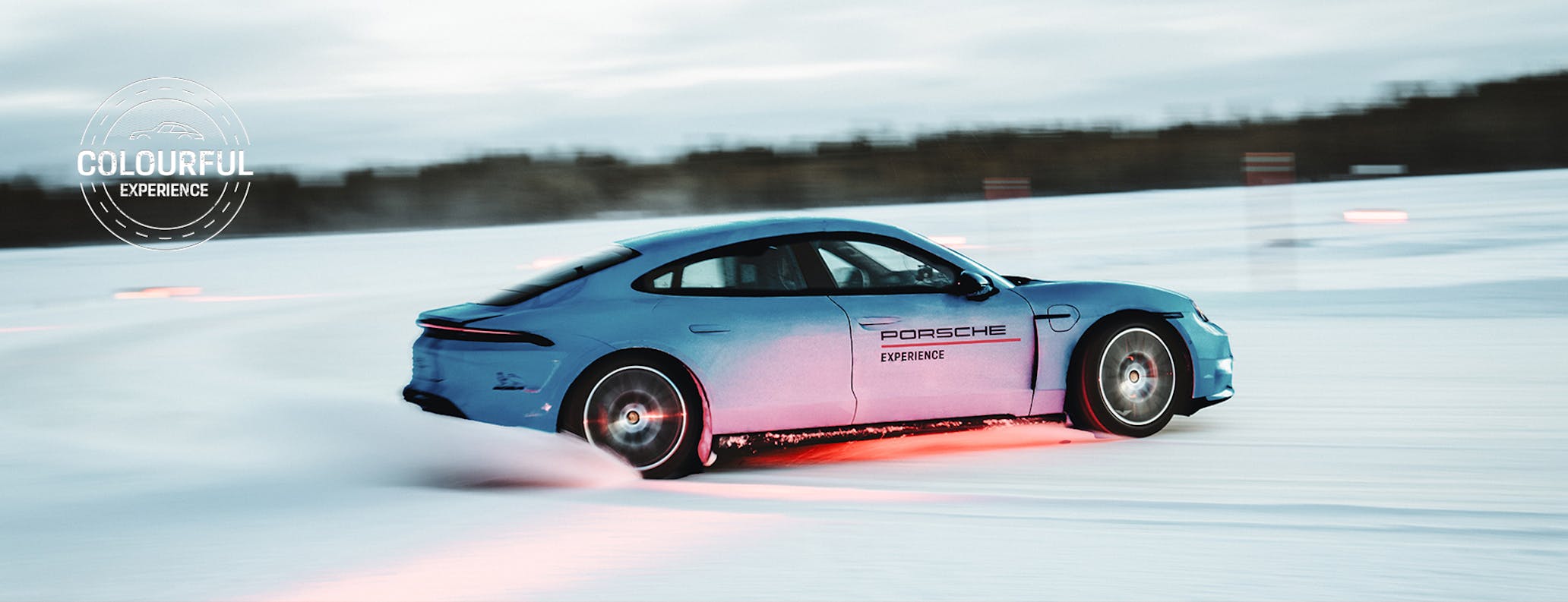 Une voiture de sport colorée en plein drift sur une surface glacée, avec un pilote professionnel aux commandes.